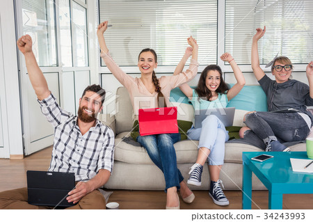 Successful remote workers looking at camera Successful remote workers looking at camera 34243993