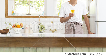 Middle-aged man's part cut relaxing in the kitchen Middle-aged man's part cut relaxing in the kitchen 34253735