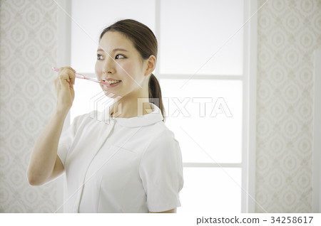 White coat woman and toothbrush White coat woman and toothbrush 34258617
