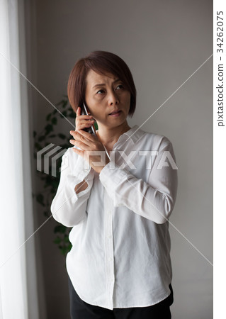 Female speaking on a cordless phone (negative) 34262075