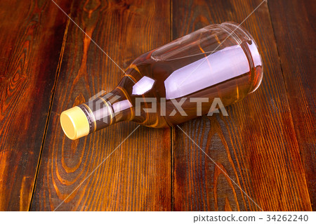 Bottle of whiskey on a wooden background . 34262240