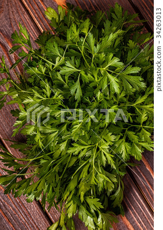 Bunch of parsley  on a wooden background. Bunch of parsley  on a wooden background. 34263013