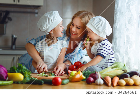 Healthy eating. Happy family mother and children prepares vegetable salad. Healthy eating. Happy family mother and children prepares vegetable salad. 34264561