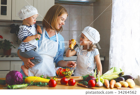 Healthy eating. Happy family mother and children prepares vegetable salad. Healthy eating. Happy family mother and children prepares vegetable salad. 34264562
