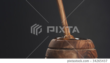 honey pot and dipper with gray background 34265437