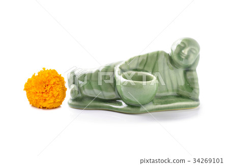 Little Monk ceramic and Yellow marigold on a white Little Monk ceramic and Yellow marigold on a white 34269101