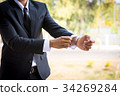 Businessman wearing a suit  and folding sleeve 34269284