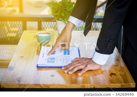 Finger business man pointing to the paper report 34269440