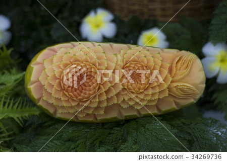 Thai fruit carving and food garnish on papaya Thai fruit carving and food garnish on papaya 34269736