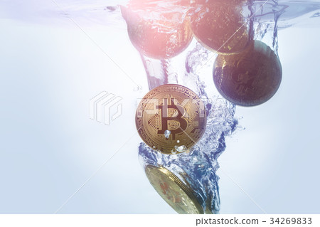 golden bitcoin coin falling into clear water 34269833