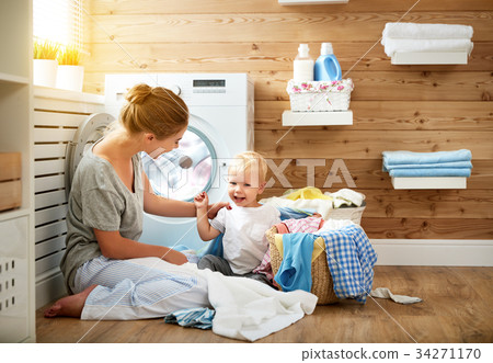 Happy family mother   housewife and children in   laundry load w 34271170