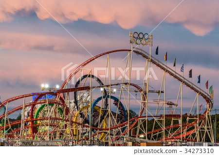 View of rollercoaster in Oktoberfest during sunset 34273310