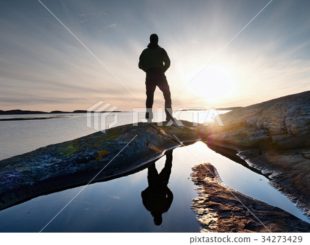 Tall backpacker watch clear sunny sea daybreak 34273429