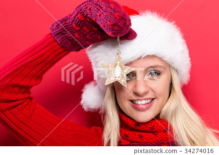 Woman holding Christmas ornament 34274016