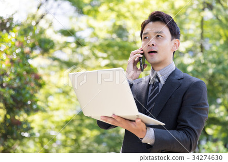 A businessman who works in the park A businessman who works in the park 34274630