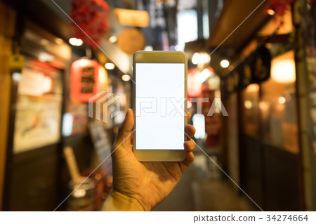 Smartphone downtown at night 34274664