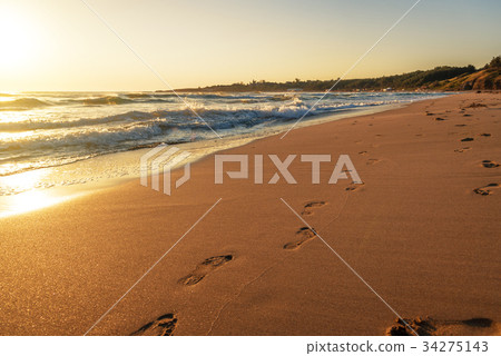 beach, wave and footprints at sunset time beach, wave and footprints at sunset time 34275143