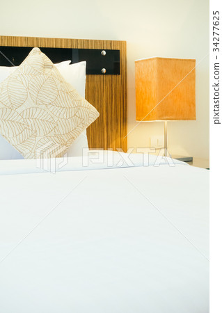 Pillow on bed with light lamp Pillow on bed with light lamp 34277625