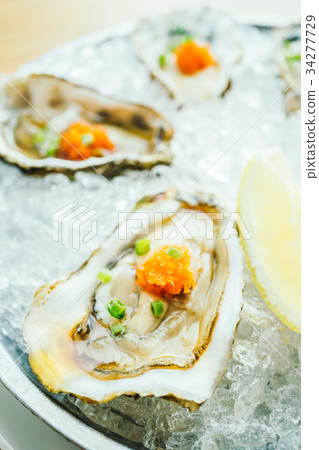 Raw and fresh oyster shell with lemon Raw and fresh oyster shell with lemon 34277729
