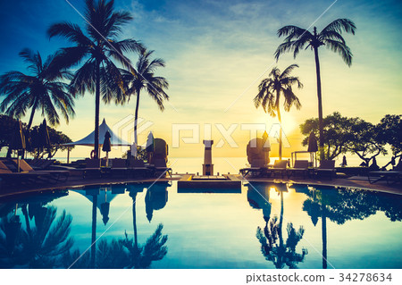 Silhouette coconut palm tree around swimming pool 34278634