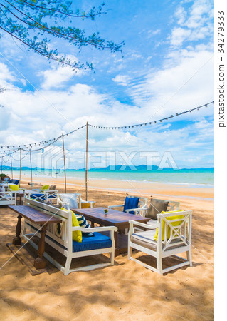 Chair and table dinning on the beach and sea with blue sky 34279333