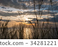 Grass and sunset on the sea and sky background. 34281221