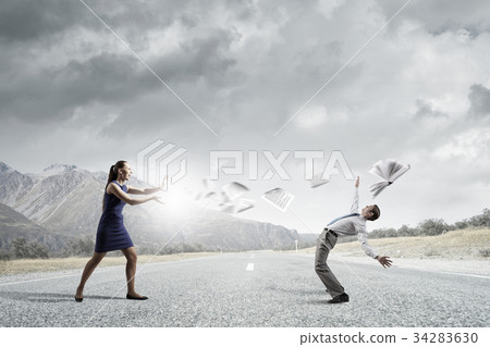 Two business people fighting with each other Two business people fighting with each other 34283630