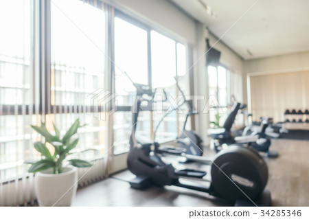 Abstract blur fitness equipment in gym room interior 34285346