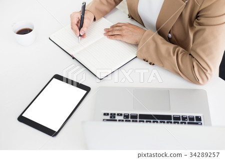 Hands of financial business women manager taking notes when work Hands of financial business women manager taking notes when work 34289257