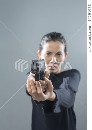 Portraits serious Asian Woman in position ready to shoot. Portraits serious Asian Woman in position ready to shoot. 34291688