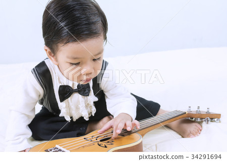 Portraits a little cute Asian boy and music. 34291694