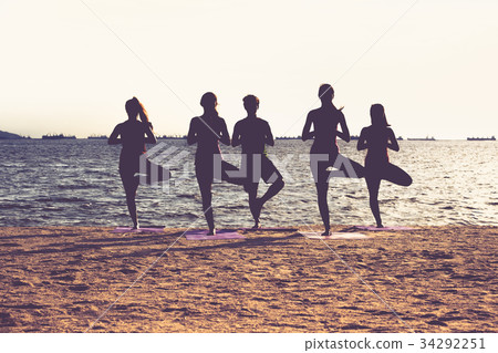 Silhouette of yoga group of people doing tree pose 34292251