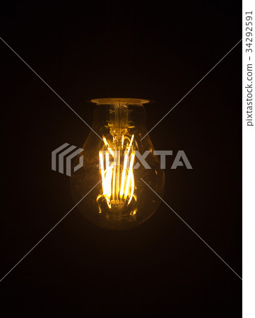 Light bulb hanging on black background. 34292591