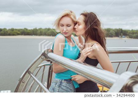 Two women are hugging. 34294400
