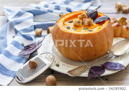 Pumpkin soup with spices and croutons in pumpkin. Pumpkin soup with spices and croutons in pumpkin. 34295902