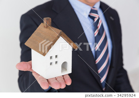 Middle male business hand with home miniatures 34295924