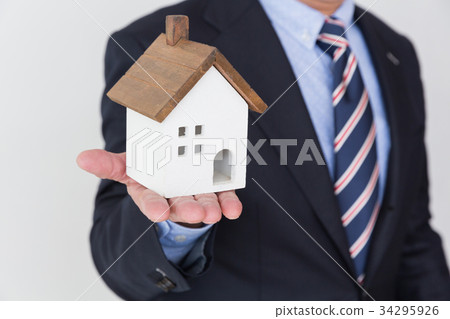 Middle male business hand with home miniatures 34295926