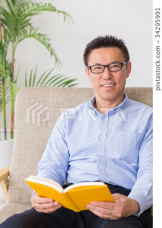 Middle male reading a book Middle male reading a book 34295991