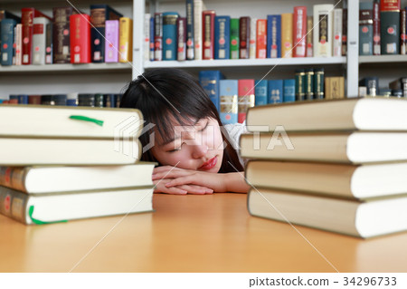 Young women doing nap in the library Photography cooperation: Nihon Keizai University Young women doing nap in the library Photography cooperation: Nihon Keizai University 34296733