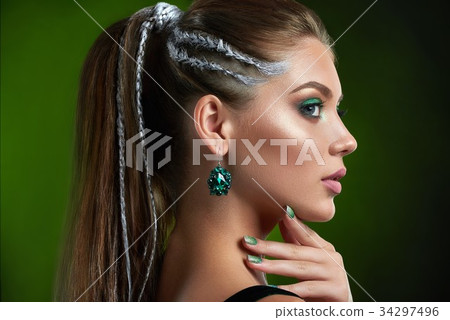 Pretty woman with makeup in green colors and 34297496