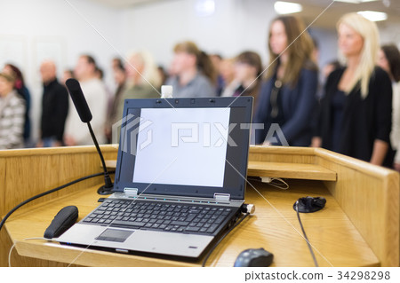 Laptop computer and microphotone at podium on 34298298