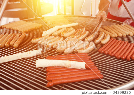 BBQ with fiery sausages on the grill 34299220