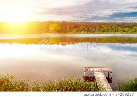 Pier on a calm river in the summer Pier on a calm river in the summer 34299256