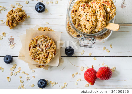 Homemade granola bar and fresh berries on wood 34300136