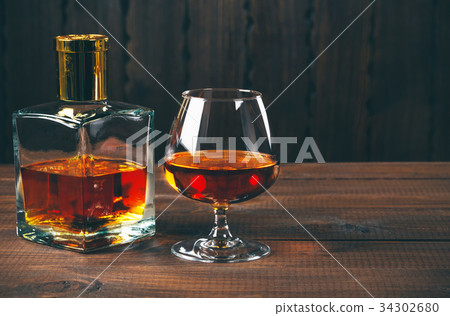 Glass of brandy or cognac and bottle  34302680
