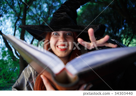 Close-up picture of witch reading spell 34303440