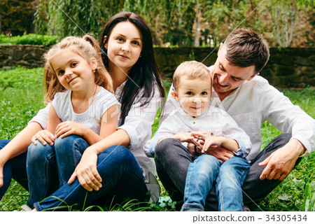 portrait of happy family mother, father, duaghter 34305434