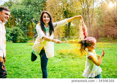 father mother and daughter full around with holi 34306168