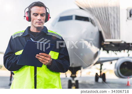 Serious male worker noting data 34306718