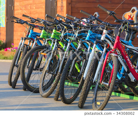 group of colorful bicycles parked together group of colorful bicycles parked together 34308002